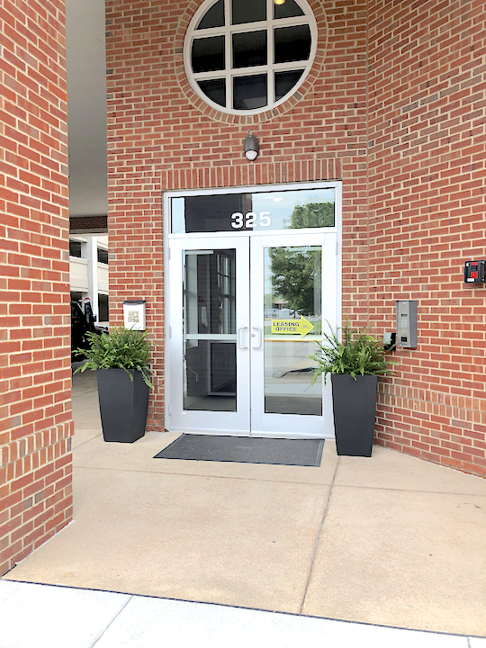Planters by residential entrance at Wabash Landing Apartments