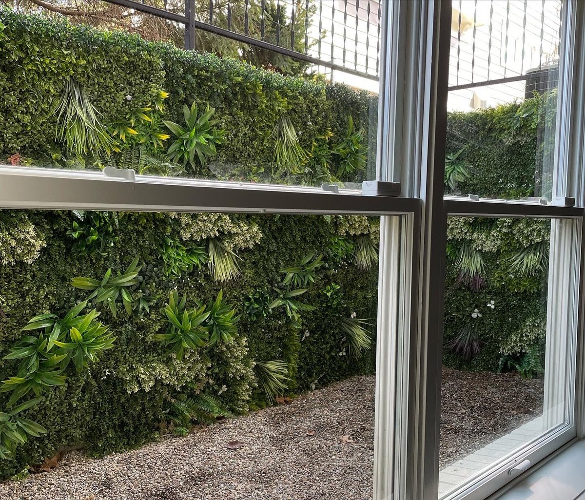 Artificial Greenery displayed in window well