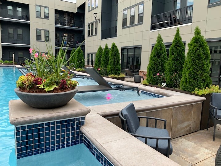 Outdoor plantscape surrounding pool at Railyard Apartments in Carmel, IN